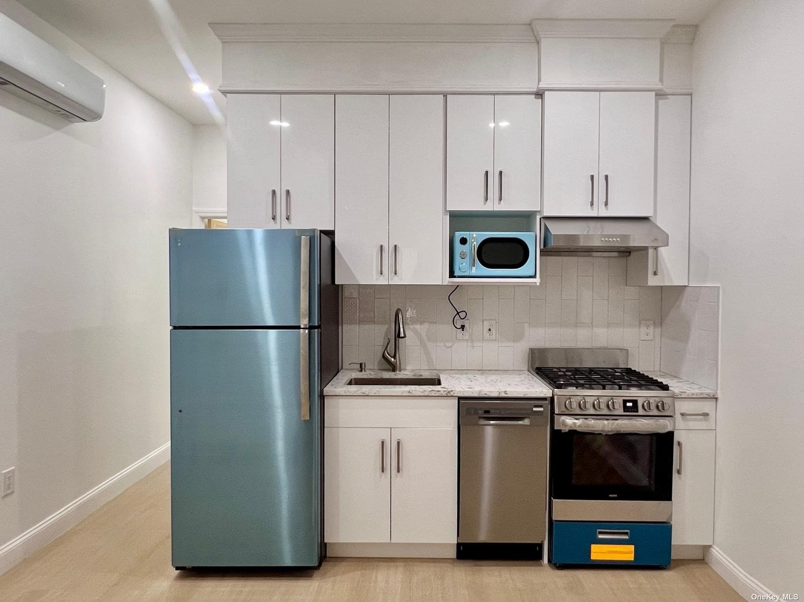 a kitchen with a stove and a refrigerator