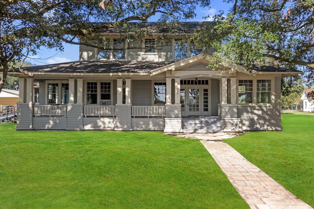 a view of a house with a yard and sitting area