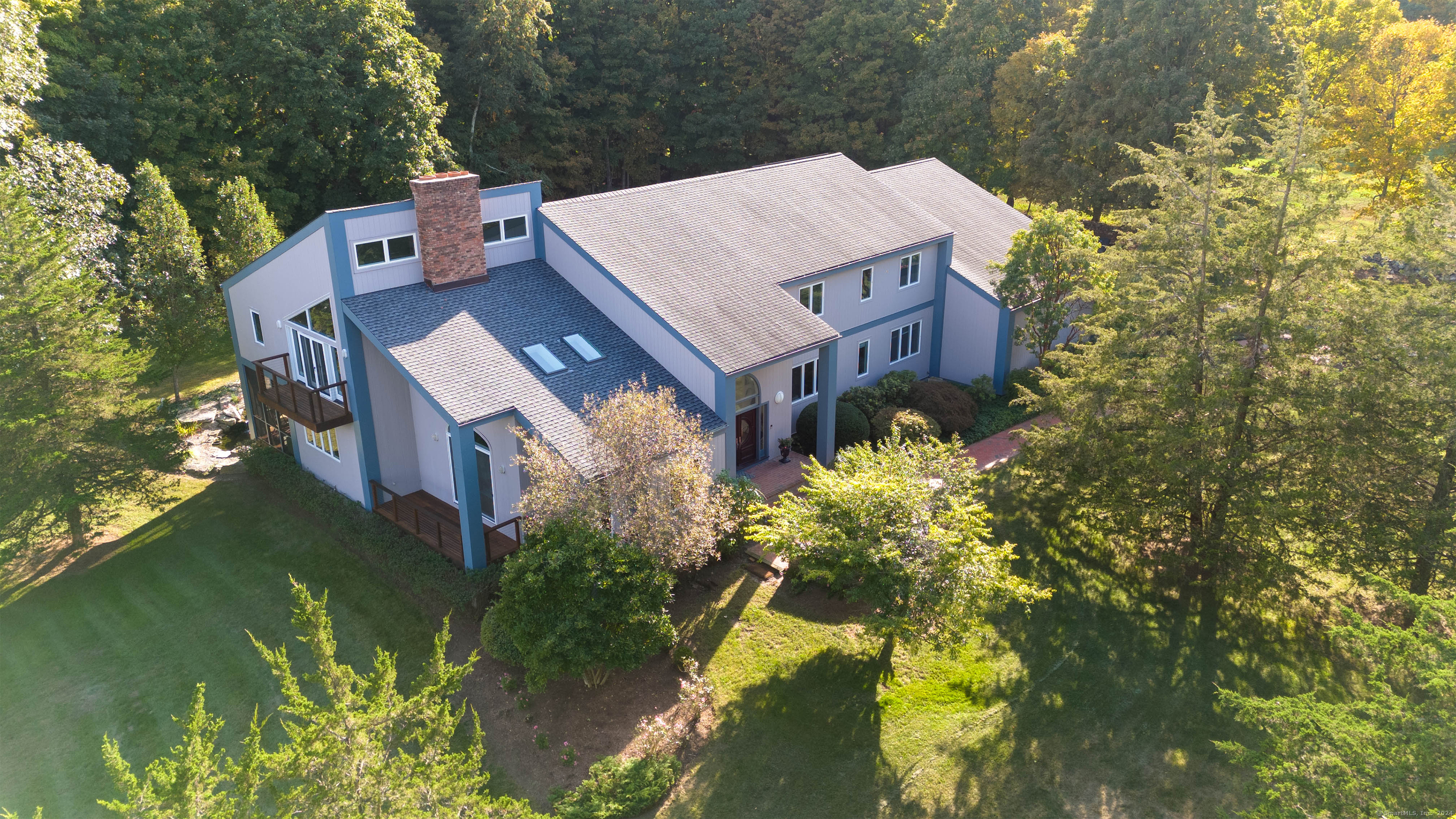 an aerial view of a house with a yard swimming pool and outdoor seating