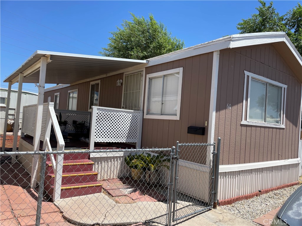 a front view of a house with wooden fence