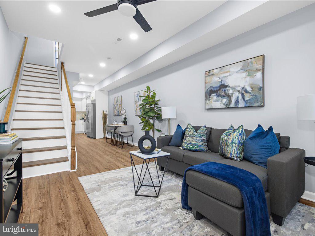 a living room with furniture and wooden floor