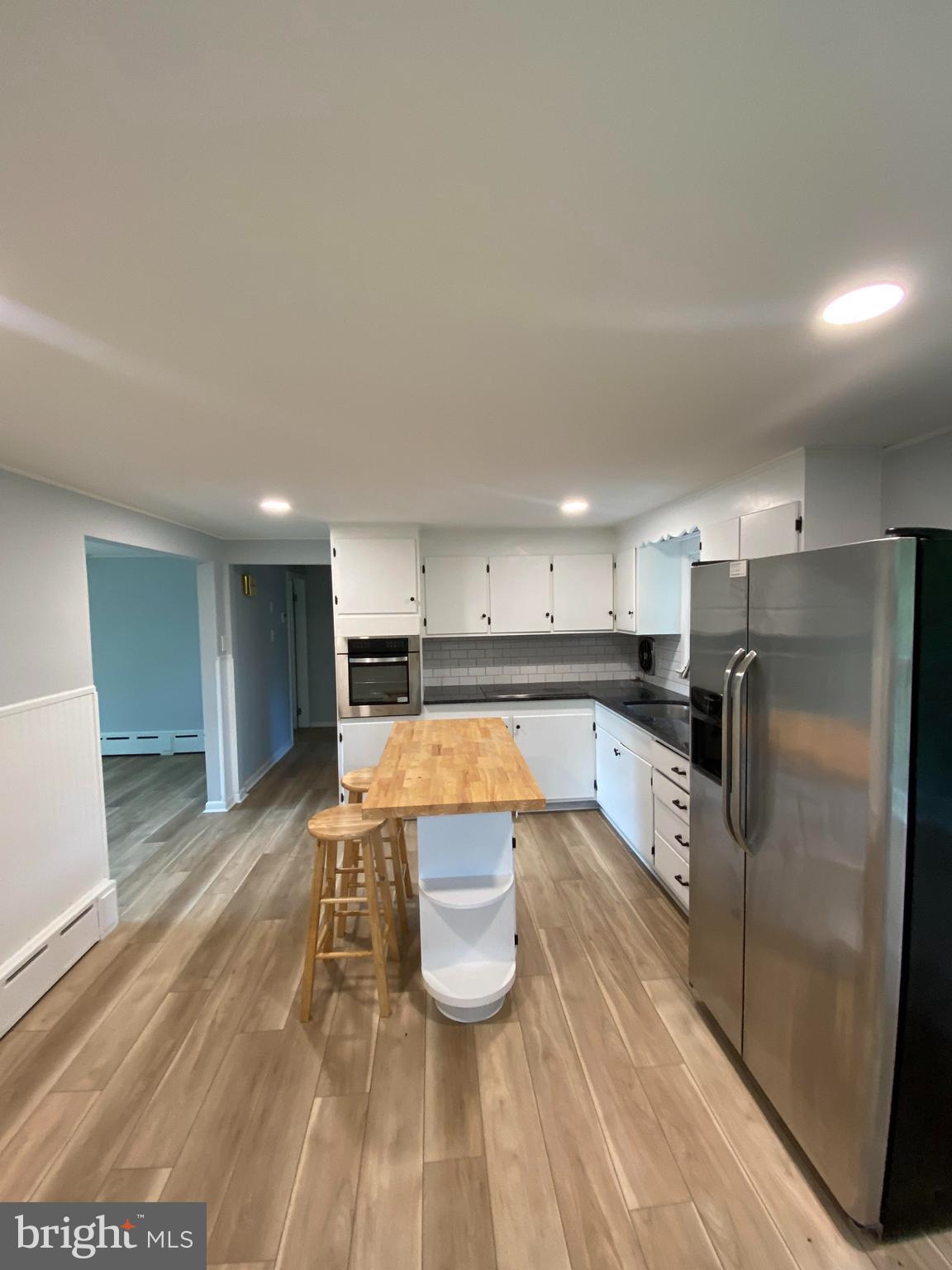 a kitchen with stainless steel appliances granite countertop a refrigerator sink and stove