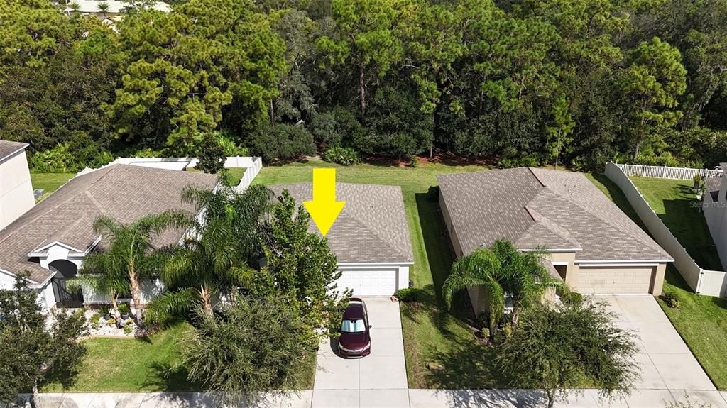 an aerial view of a house with swimming pool and garden