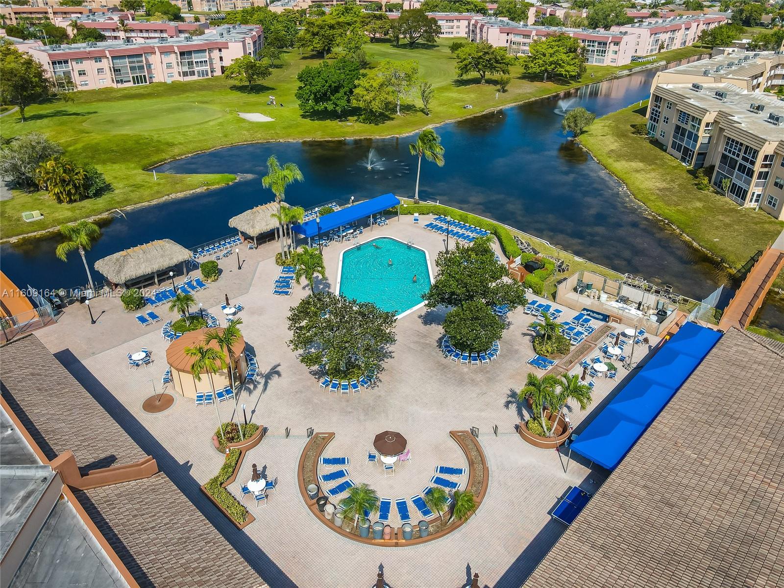 an aerial view of a house swimming pool a yard and lake view