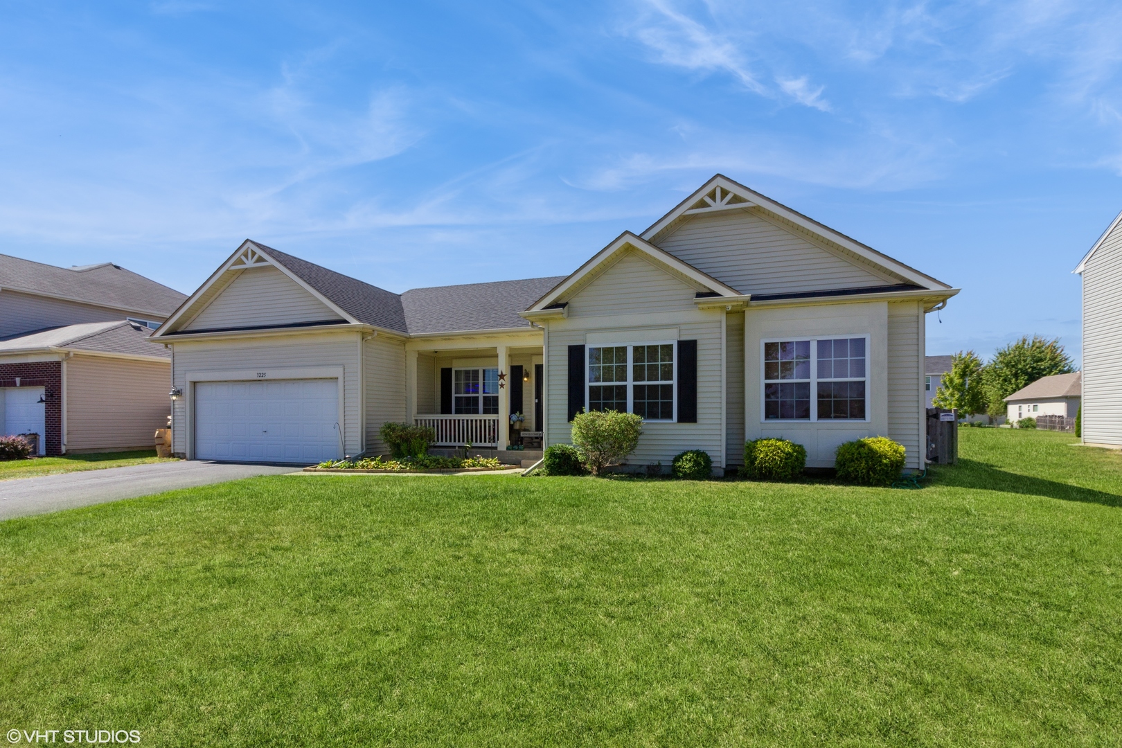 a front view of a house with a yard and garage