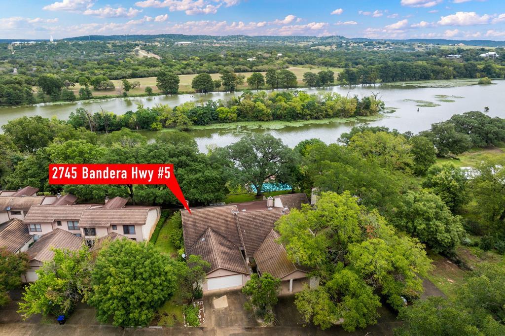 an aerial view of a houses with outdoor space and lake view