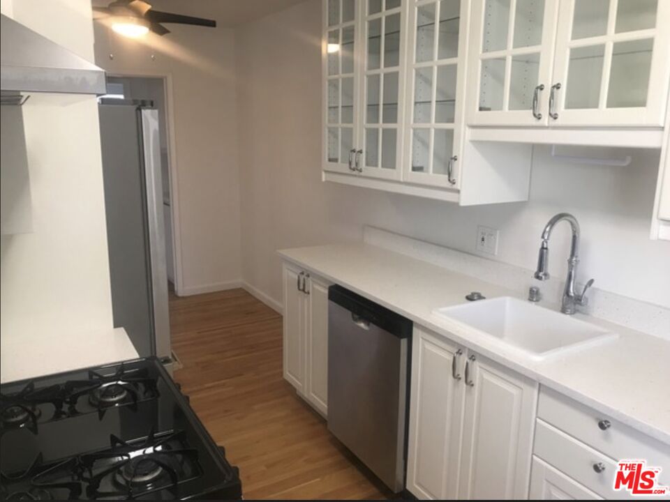 a kitchen with a sink and a mirror