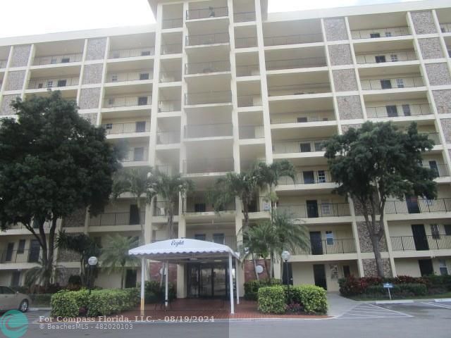 a front view of a building with a garden