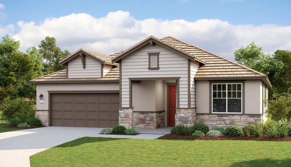 a front view of a house with a garden and garage