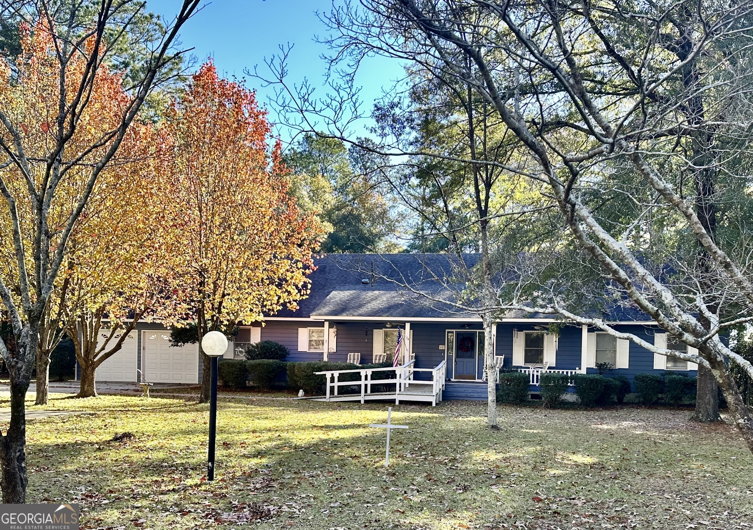 a view of a house with a yard balcony and a tree