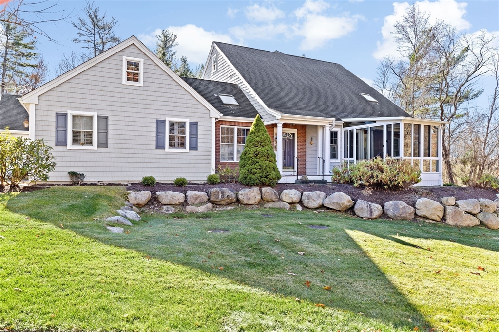 a front view of house with yard and outdoor seating