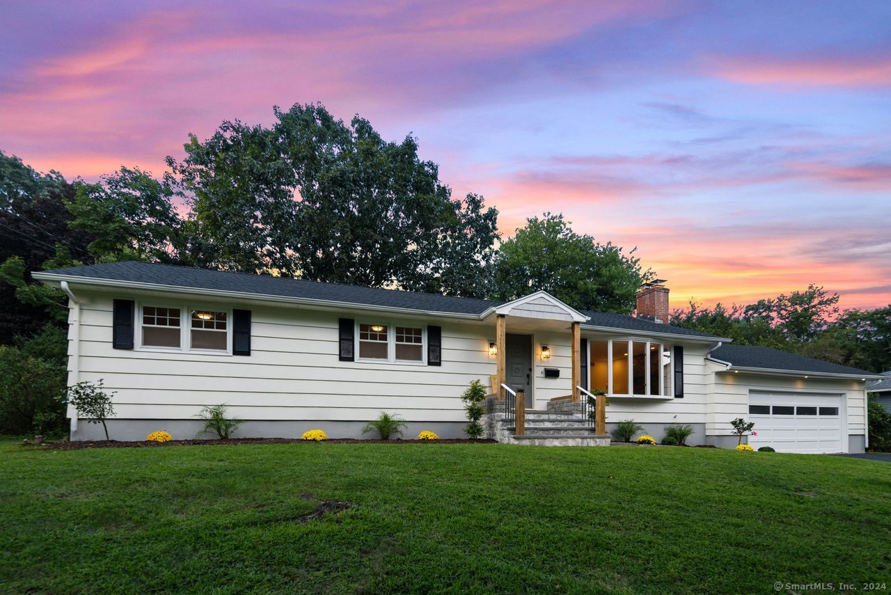 a front view of a house with a garden