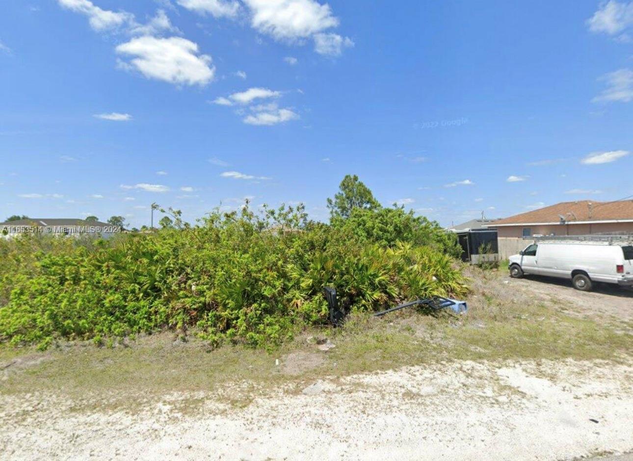 a view of a yard with car parked