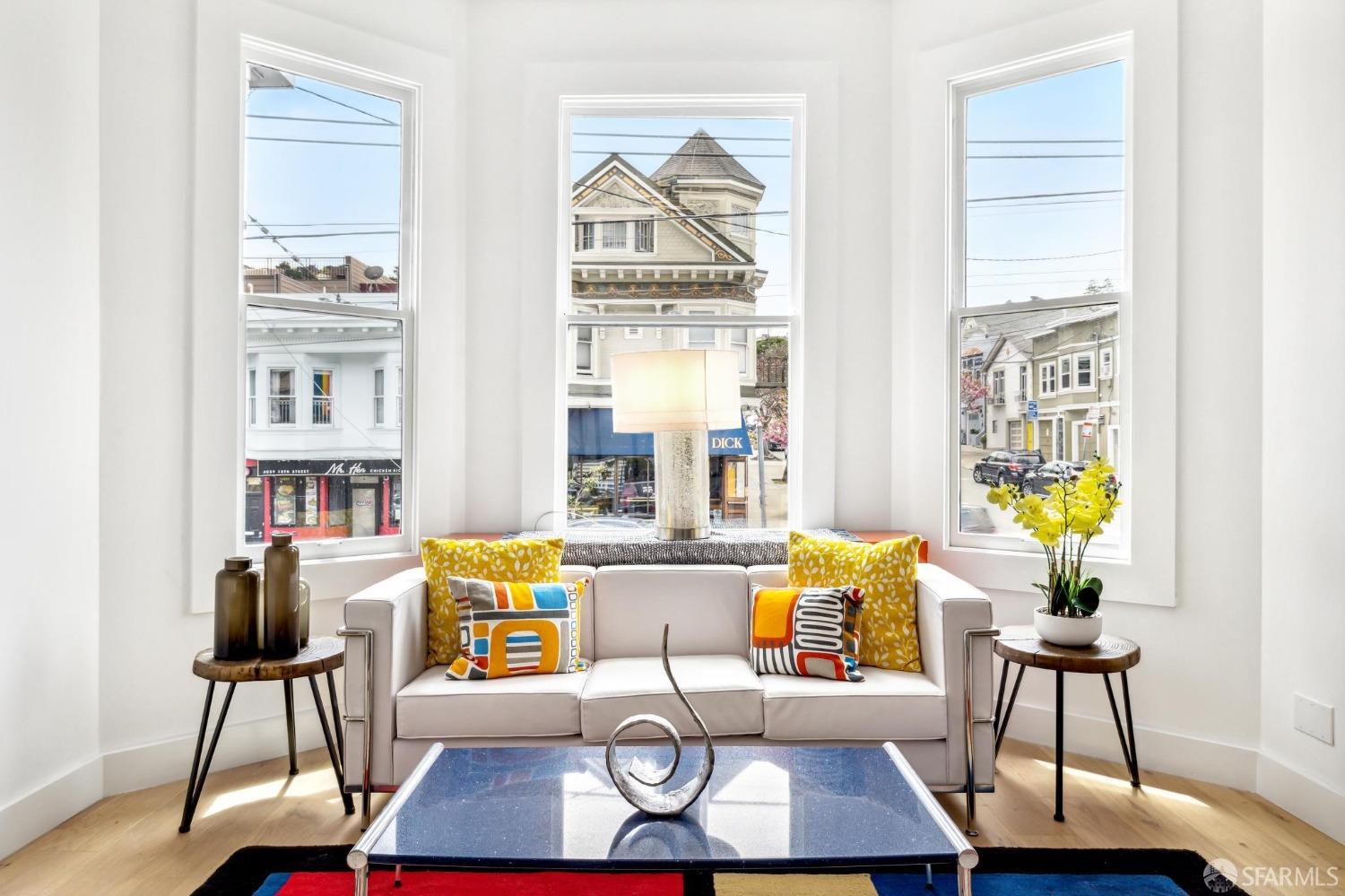 a living room with furniture and a floor to ceiling window