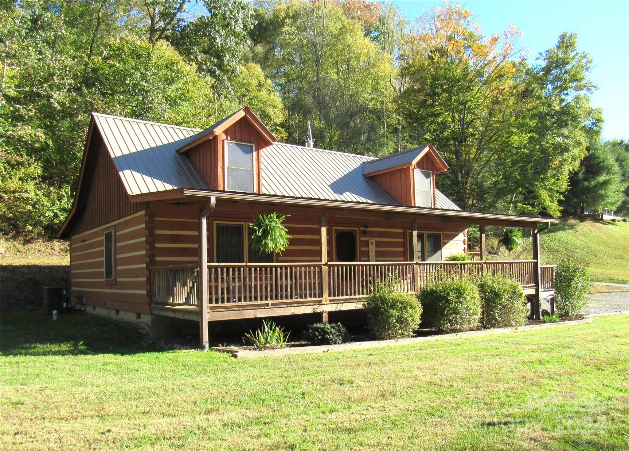 a view of a house with a yard and sitting area