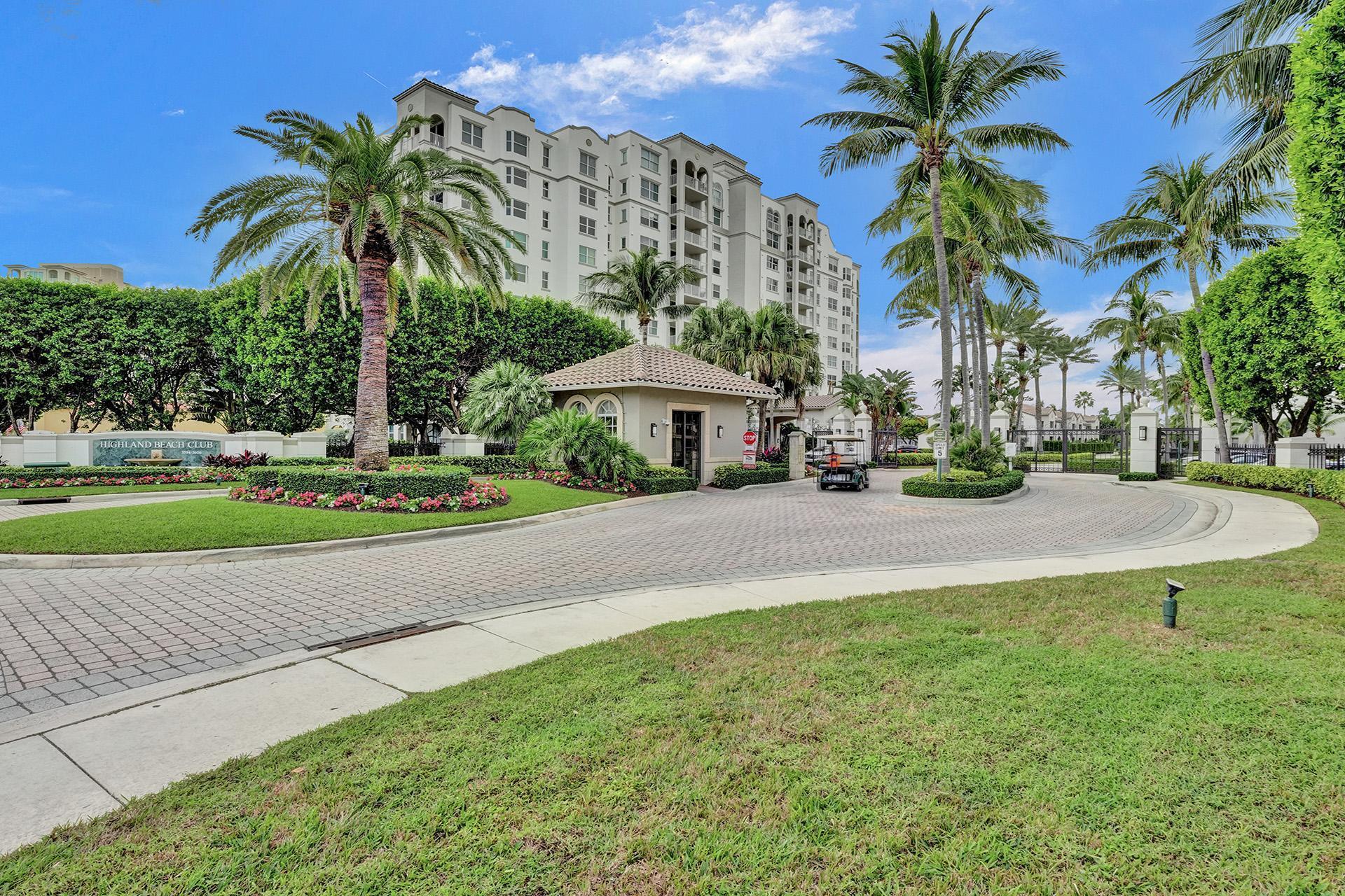 a view of a house with a yard and palm trees