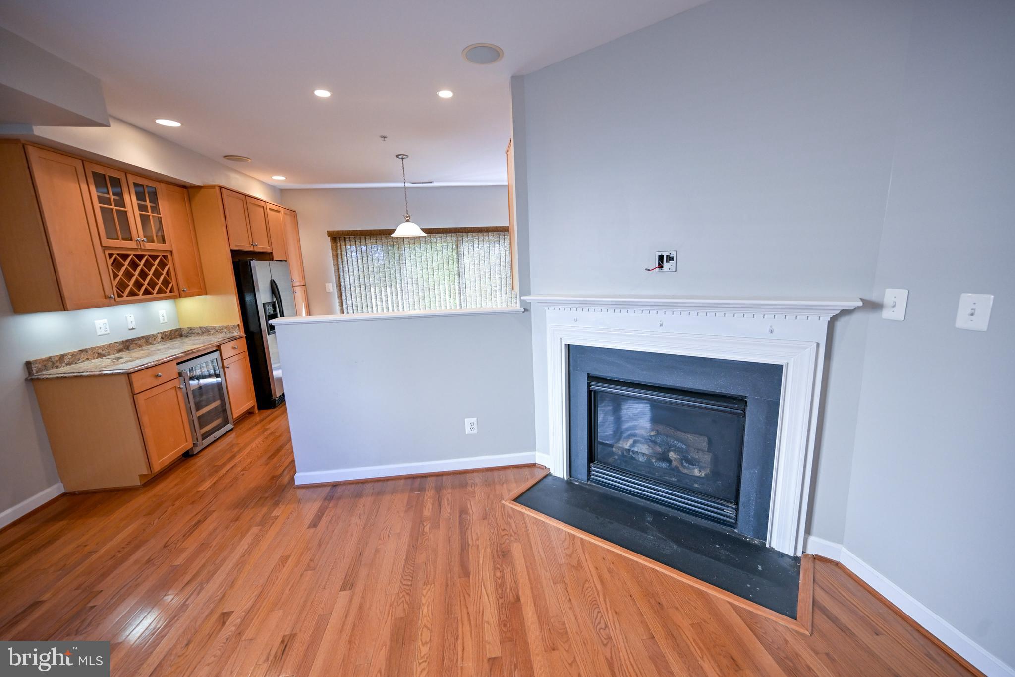 a view of a room with wooden floor and fireplace