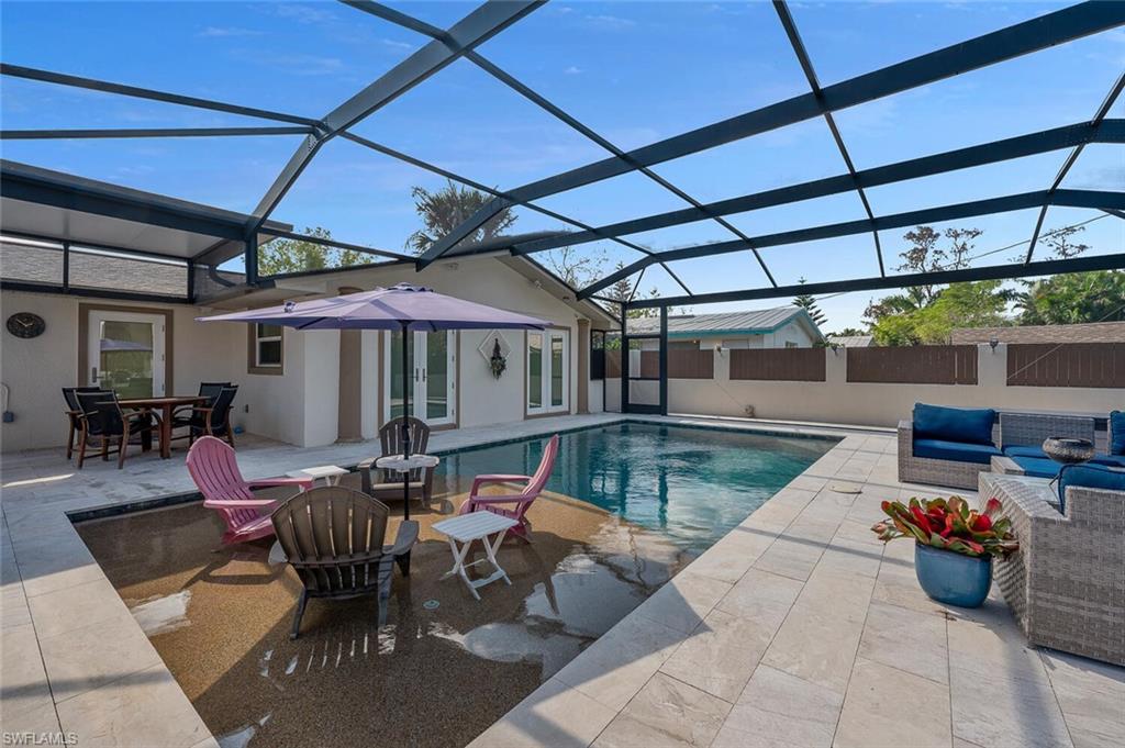 a view of a patio with table and chairs under an umbrella