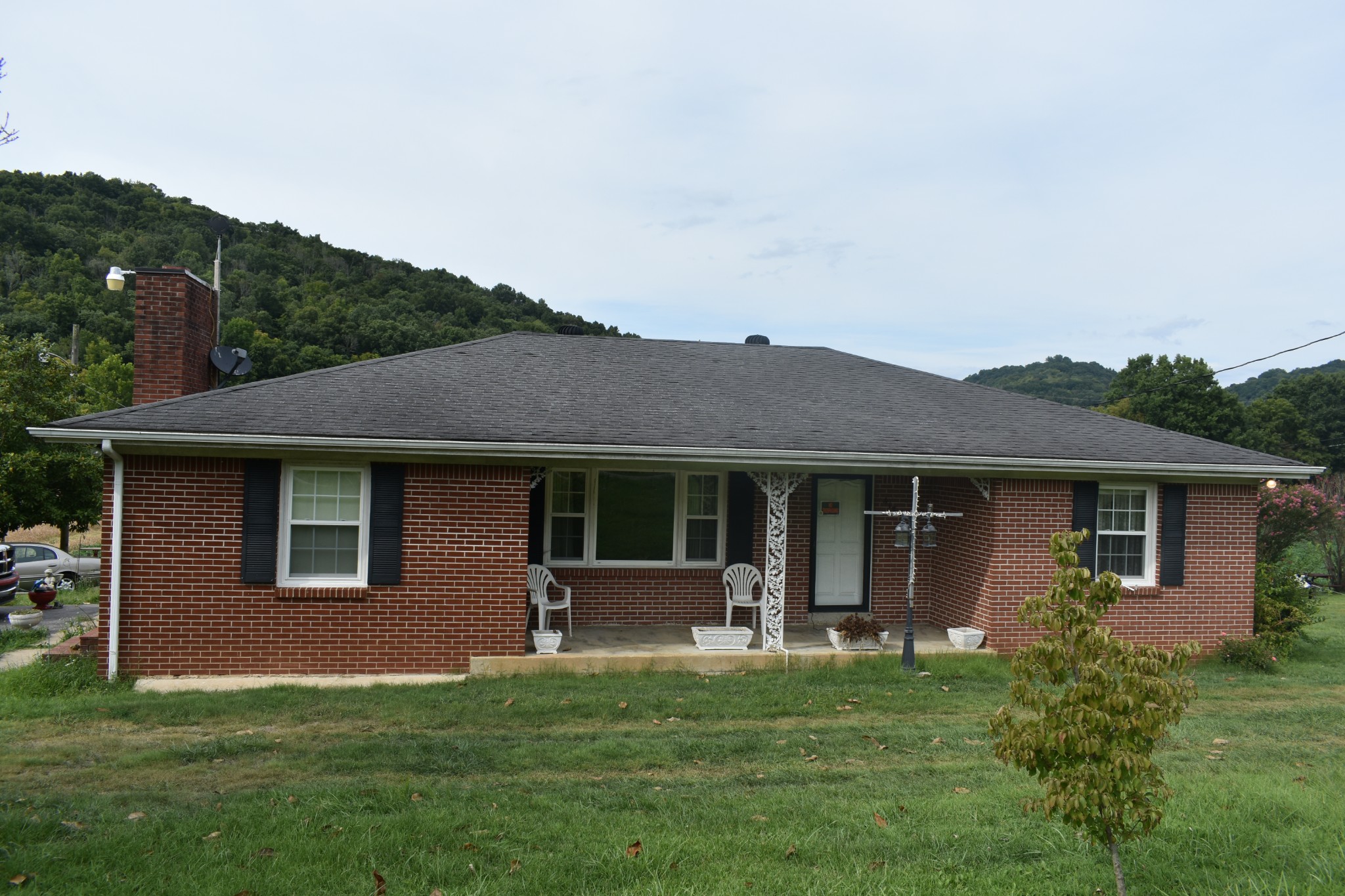 a front view of house with yard and green space