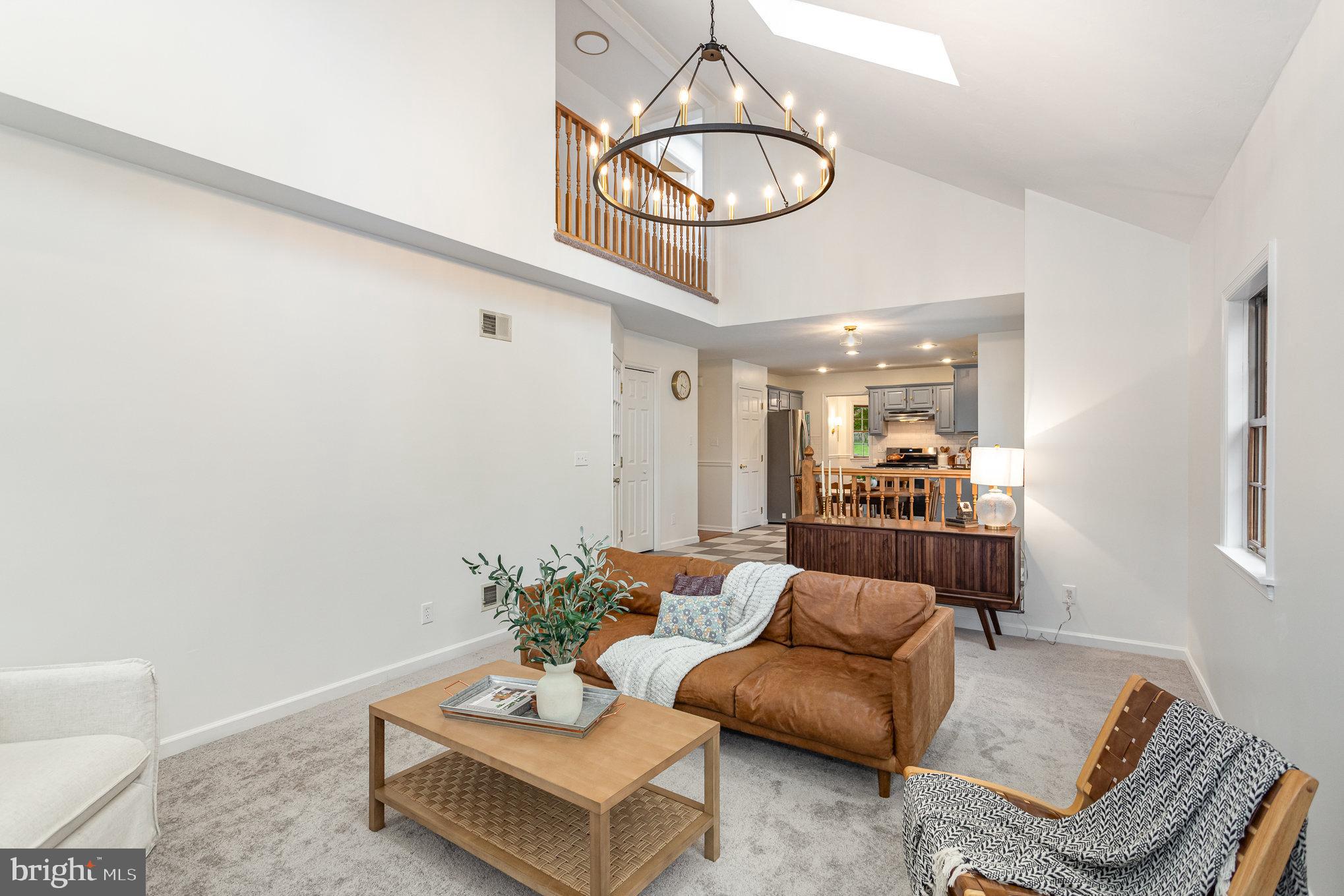 a living room with furniture and a mirror