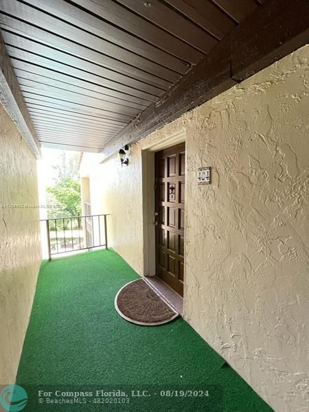 a view of a backyard with plants and a patio