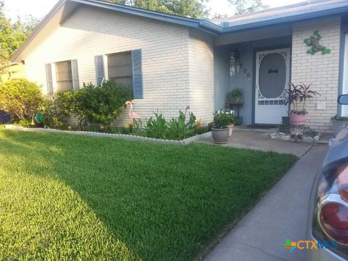 a front view of a house with garden