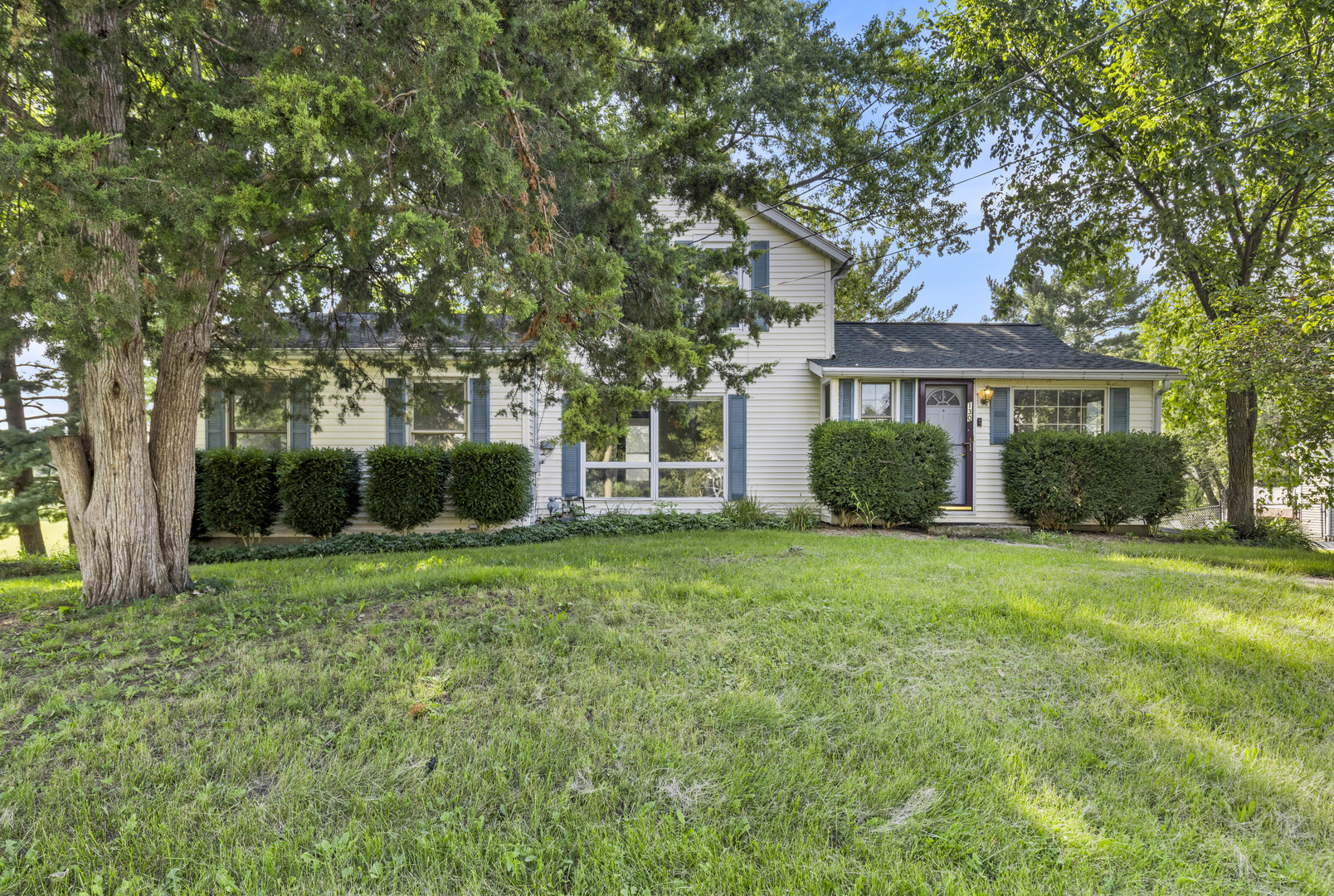 a view of a house with yard and tree s