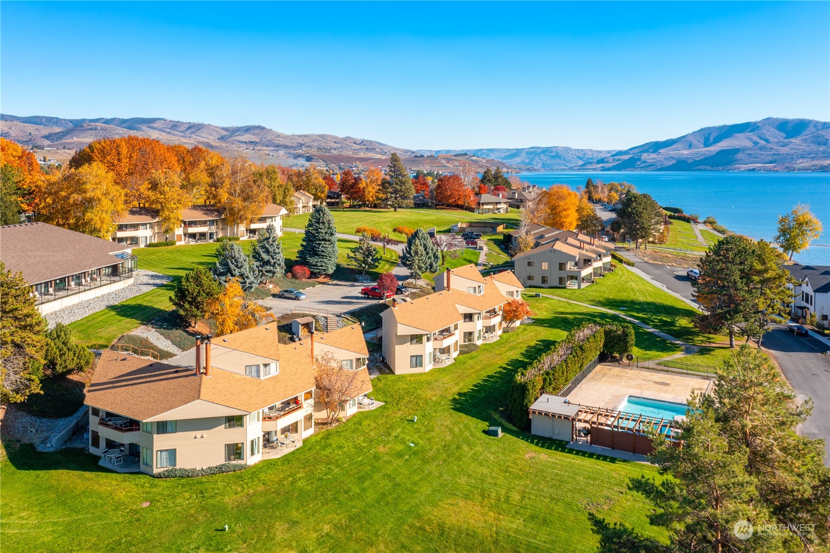 an aerial view of residential houses with outdoor space and swimming pool