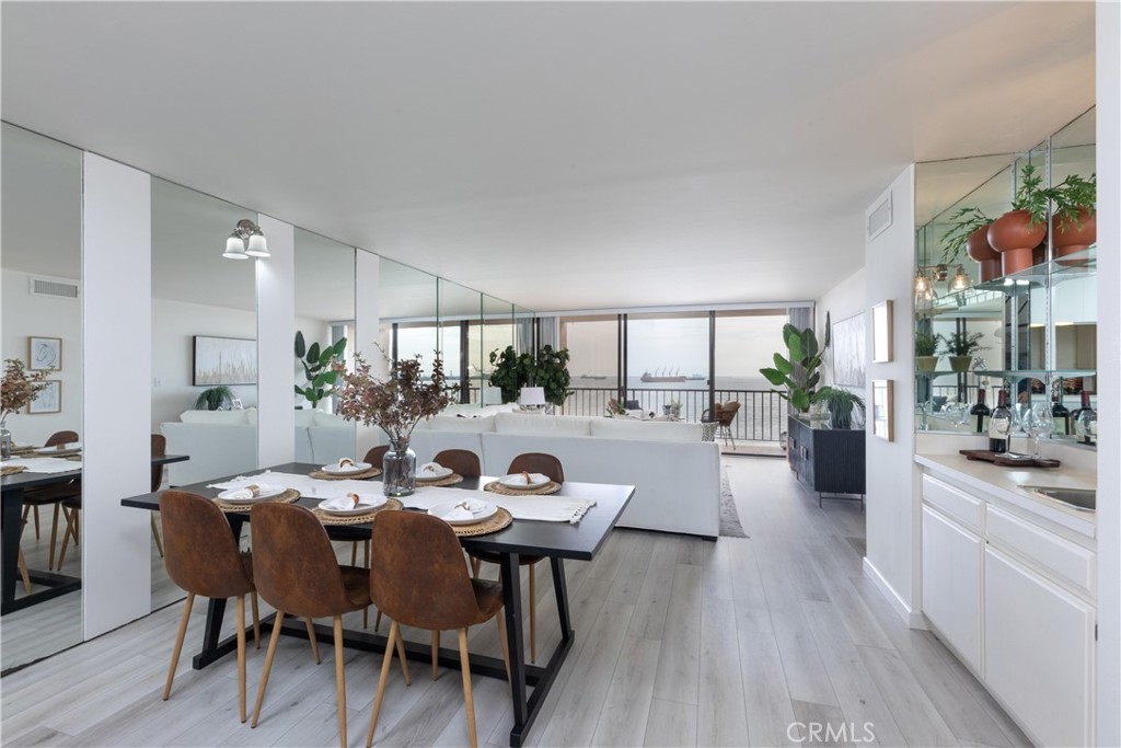 a view of a dining room and livingroom with furniture wooden floor and a rug