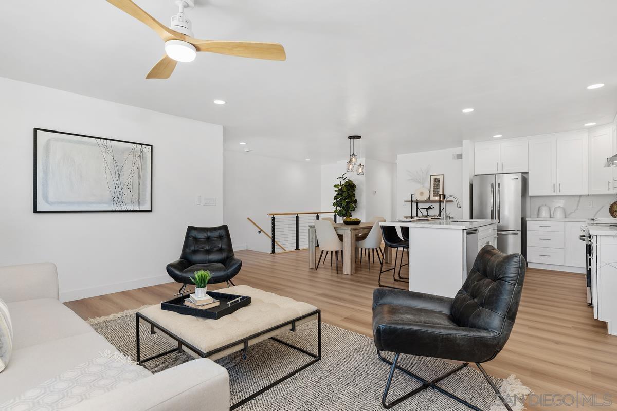 a living room with furniture and kitchen view