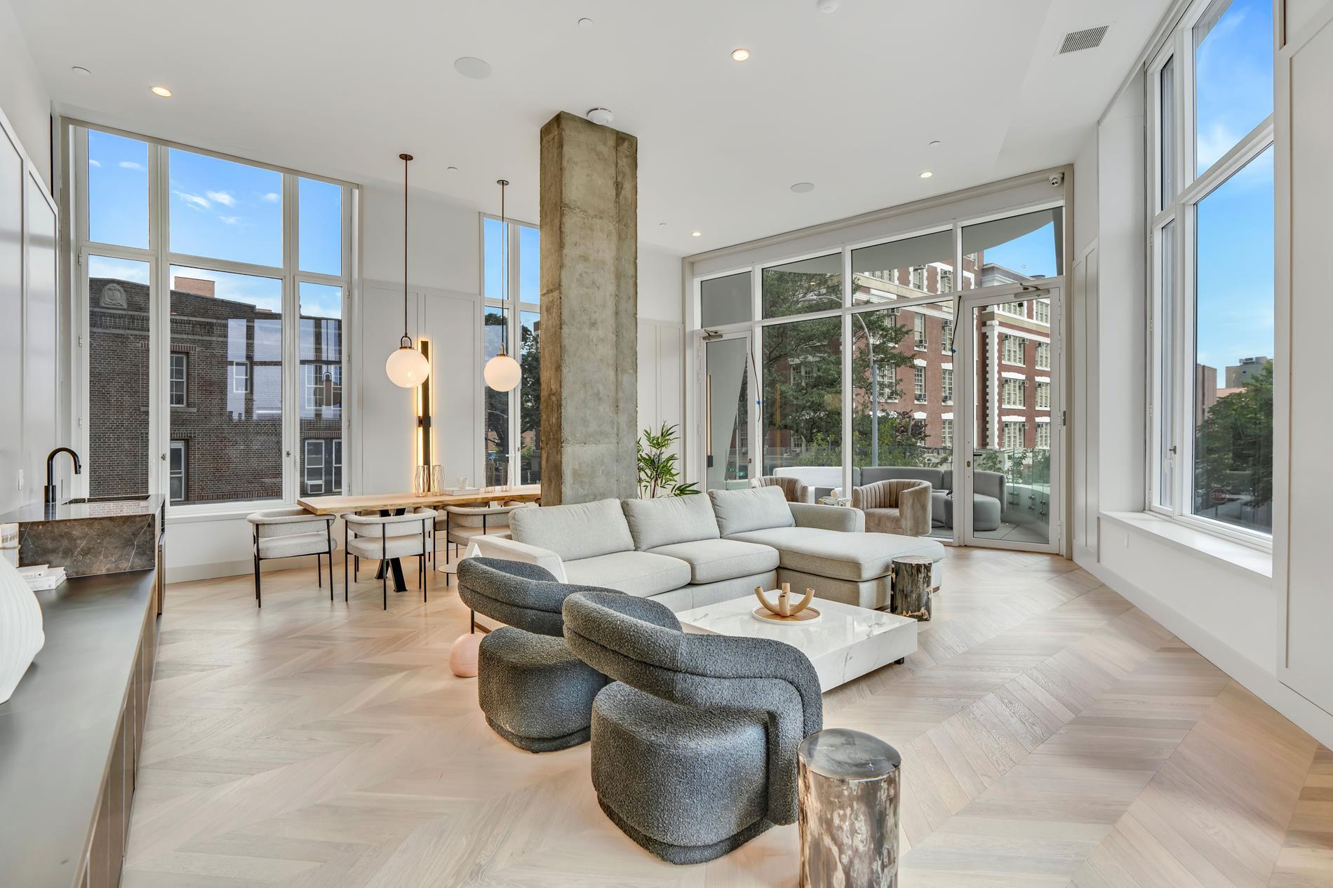 a living room with furniture and large windows