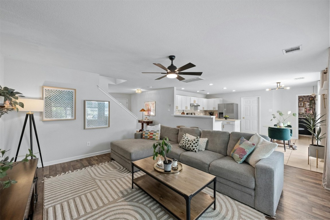 a living room with furniture and a wooden floor