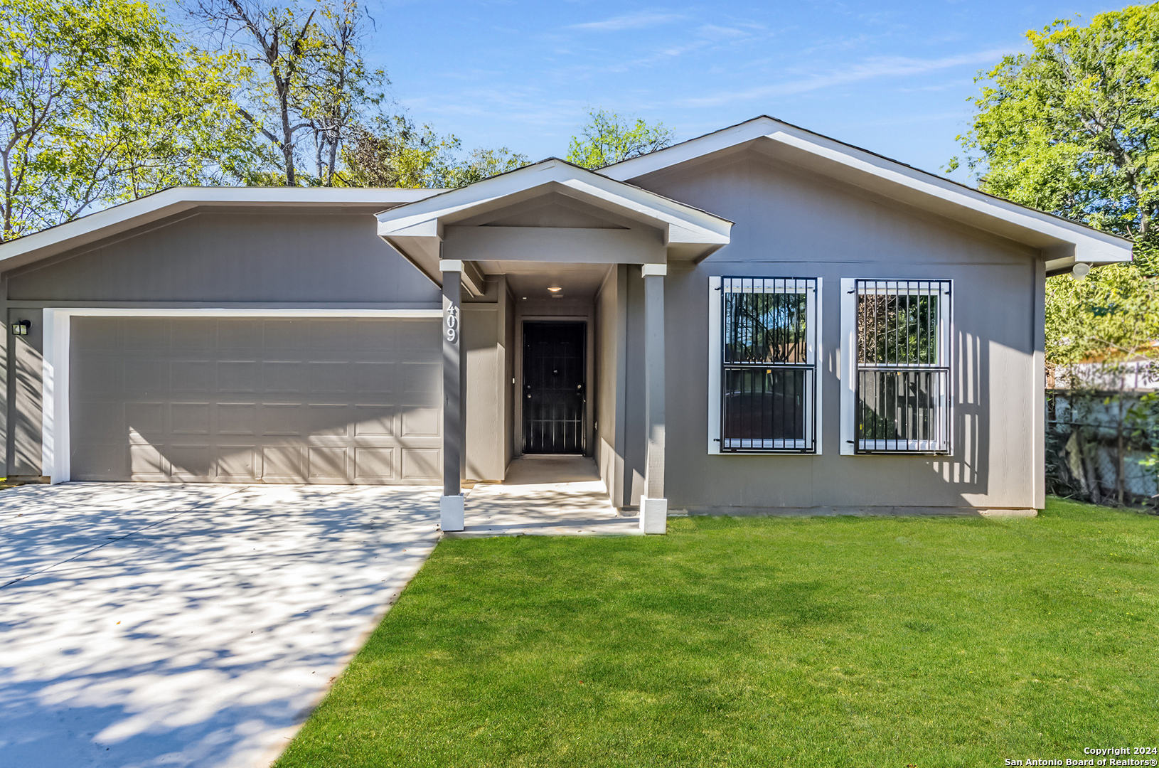 a front view of a house with a yard