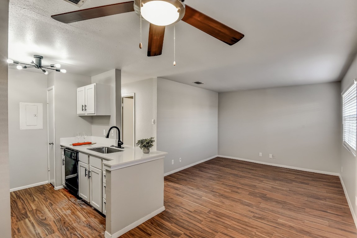 a room with a sink and a stove top oven