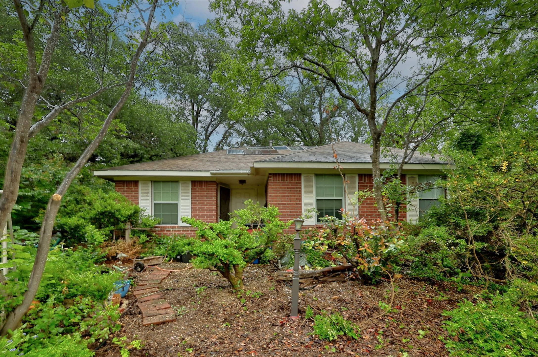 a front view of a house with a garden