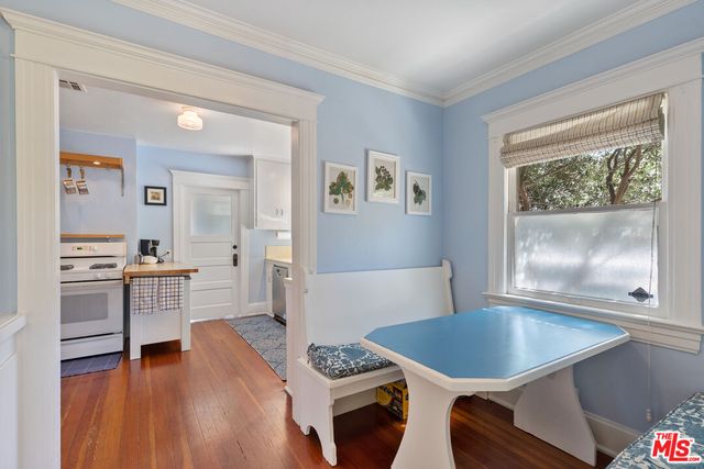 a kitchen with a table chairs sink and cabinets