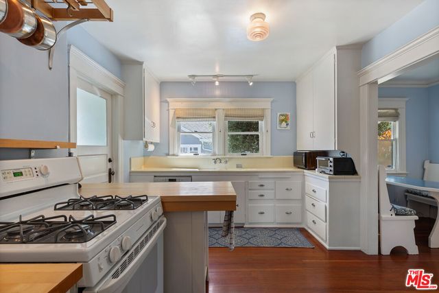 a kitchen with a stove a sink and a refrigerator