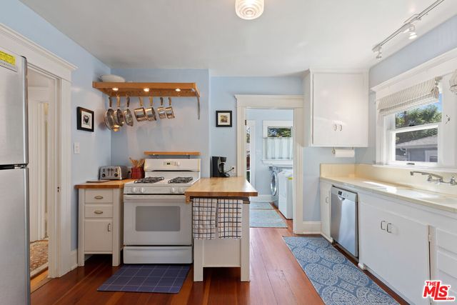 a kitchen with a stove and cabinets