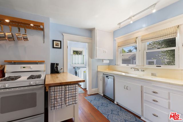 a kitchen that has a sink and a stove