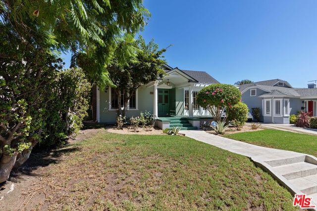 a view of a house with backyard porch and sitting area