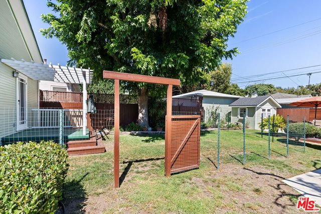 a view of a house with a yard and sitting area