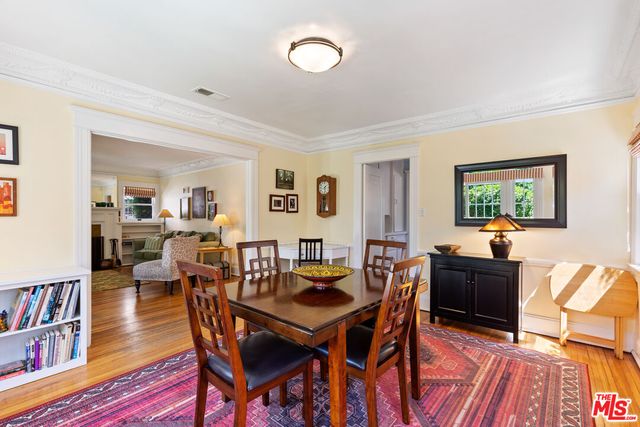 a dining room with furniture and wooden floor