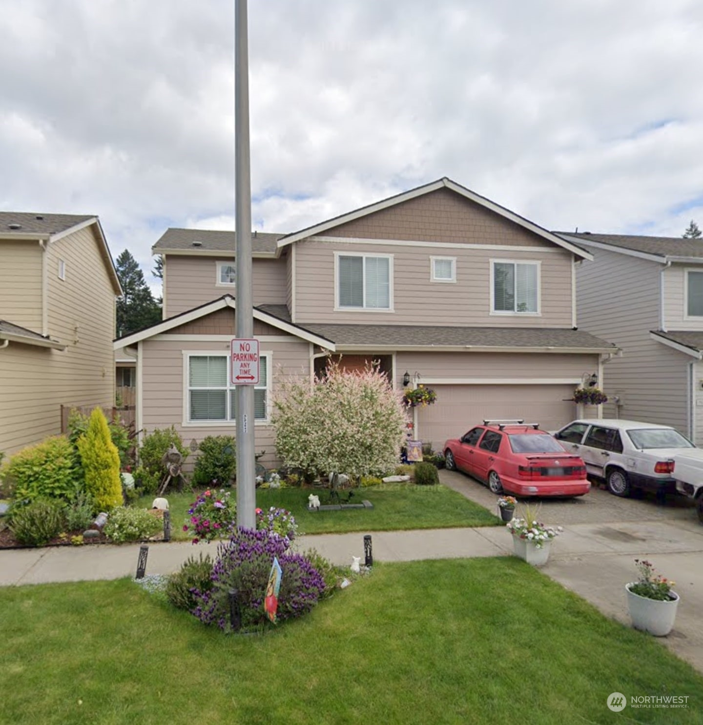 a front view of a house with a garden