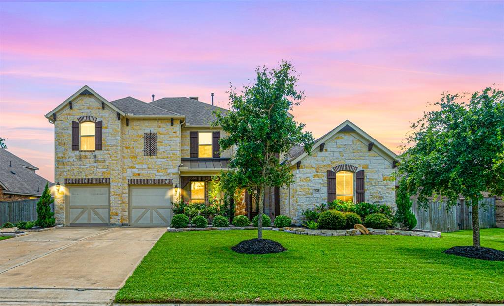 a front view of a house with a yard and garage