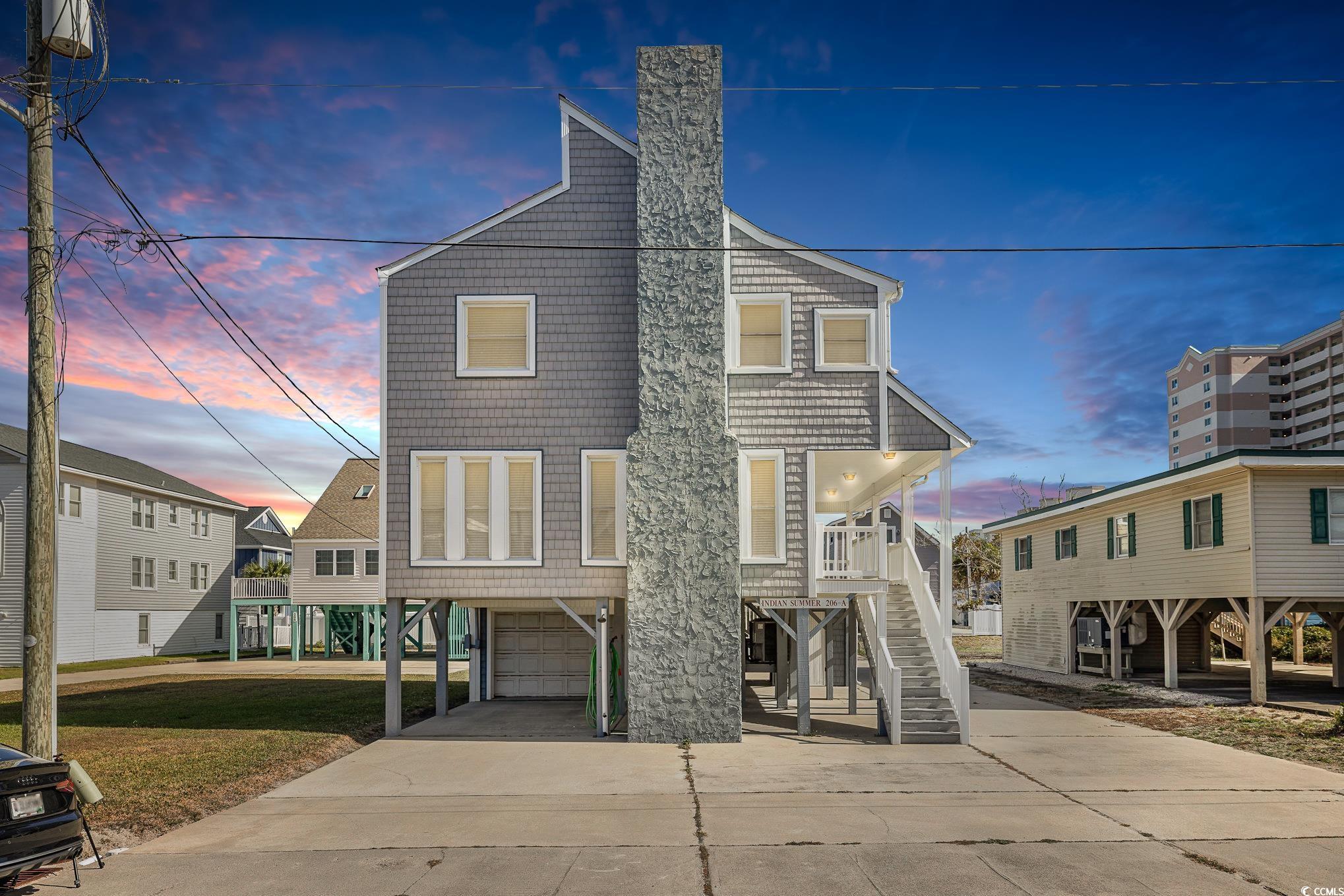 View of front facade featuring a carport