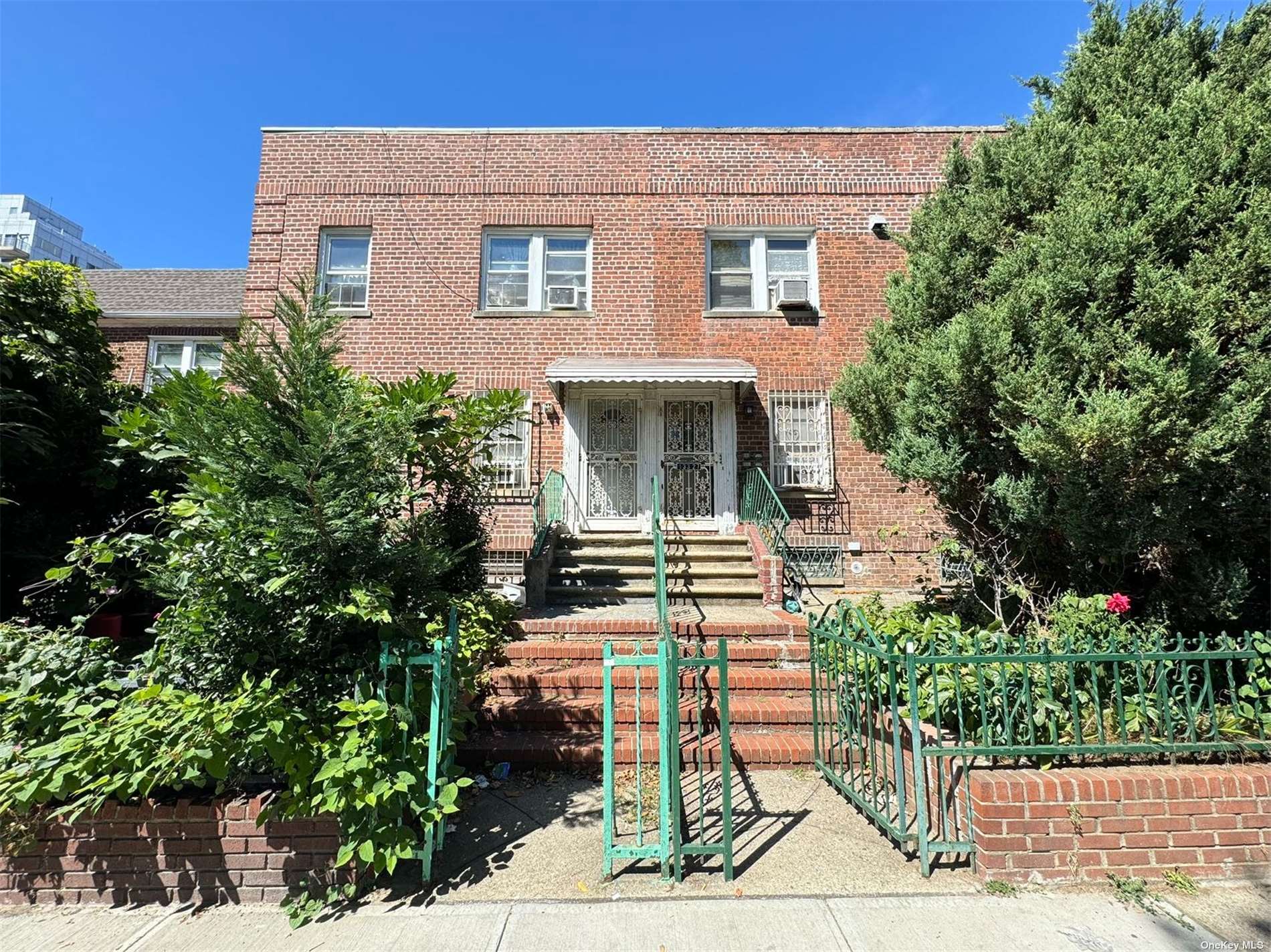 a front view of a house with plants