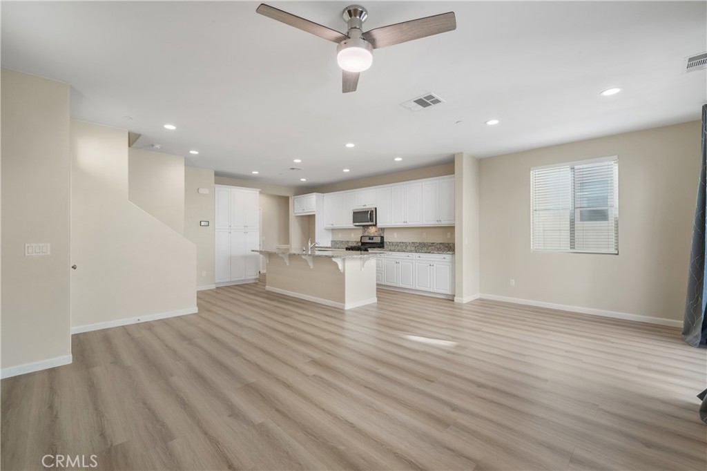 a view of kitchen with wooden floor and window