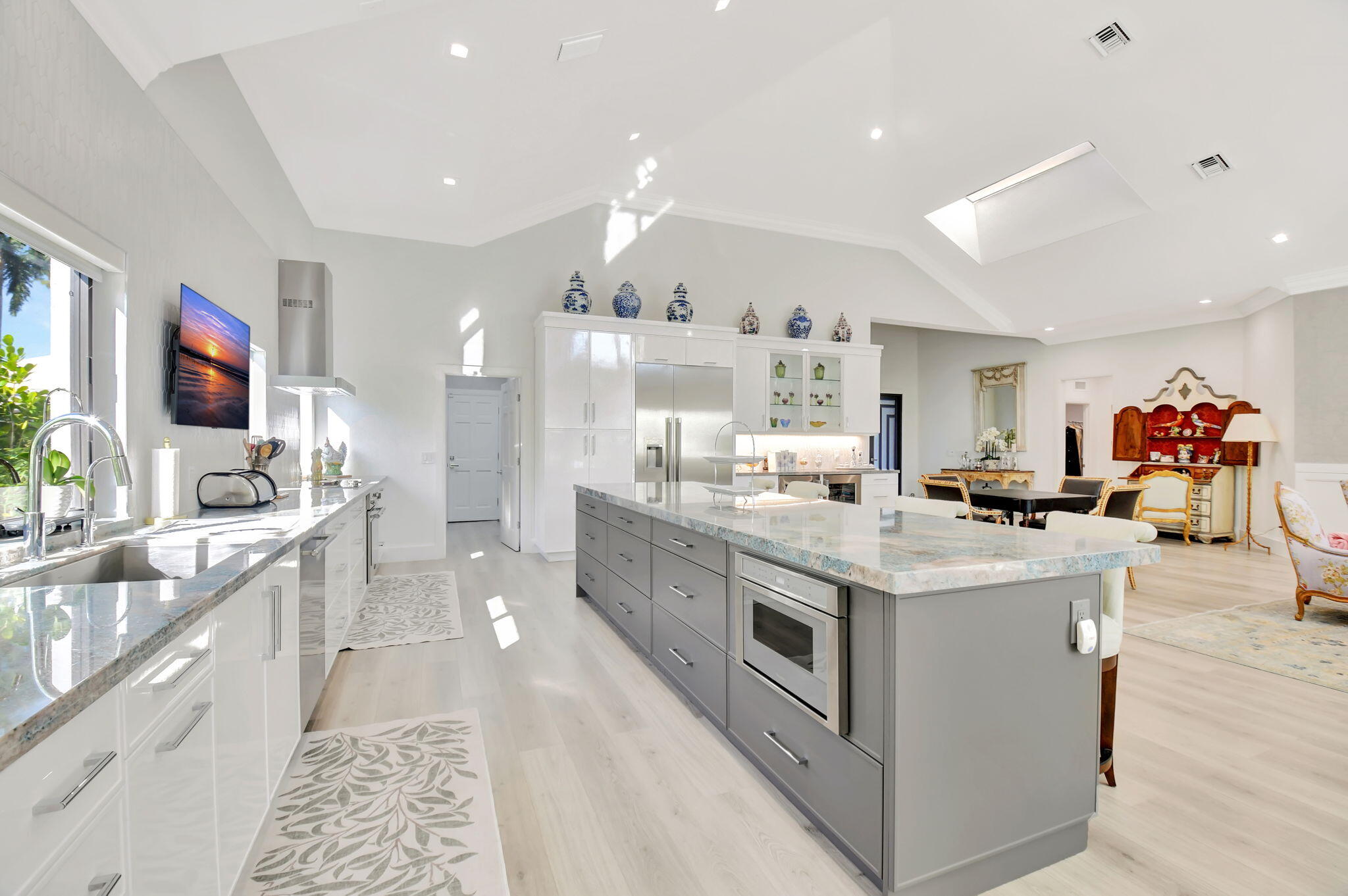 a large kitchen with stainless steel appliances kitchen island granite countertop a large counter top and sink