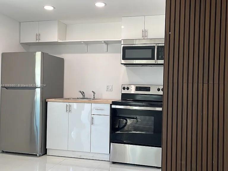 a kitchen with a stove and a microwave