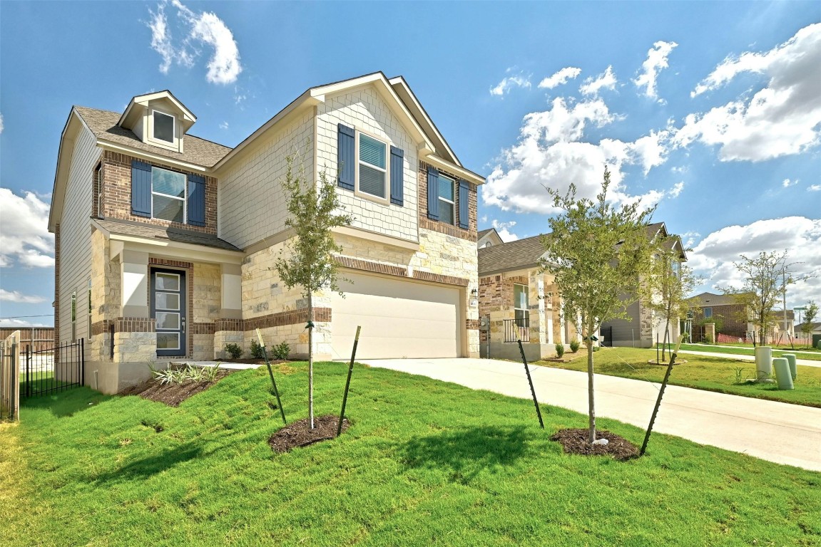 a view of a house with a backyard